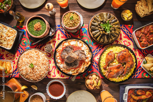 Arabic Cuisine: Middle Eastern traditional lunch. It's also Ramadan "Iftar". The meal eaten by Muslims after sunset during Ramadan. Assorted of Arabic oriental dishes. Top view with close up. 