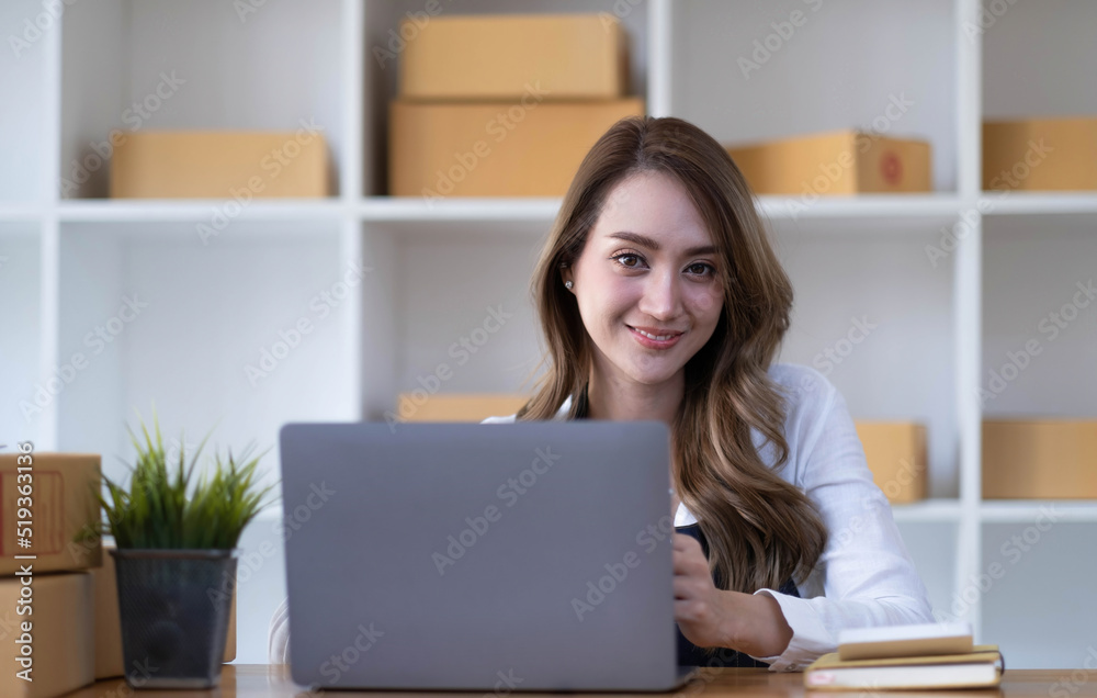 Portrait of Asian young woman SME working with a box at home the workplace.start-up small business owner, small business entrepreneur SME or freelance business online and delivery concept. Portrait of Asian young woman SME working with a box at home the workplace.start-up small business owner, small business entrepreneur SME or freelance business online and delivery concept.