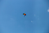 Parasailing in blue sky. Parachute sports, active leisure, travel, vacation concept. Freedom and active lifestyle