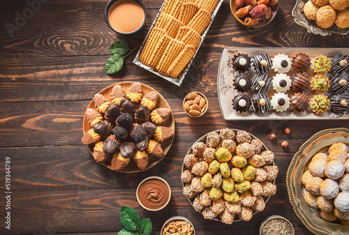 Arabic Cuisine; Cookies for celebration of El-Fitr Islamic Feast.(The Feast that comes after Ramadan). Varieties of Eid Al-Fitr sweets (kahk,biscuits, petit four). Top view with copy space.