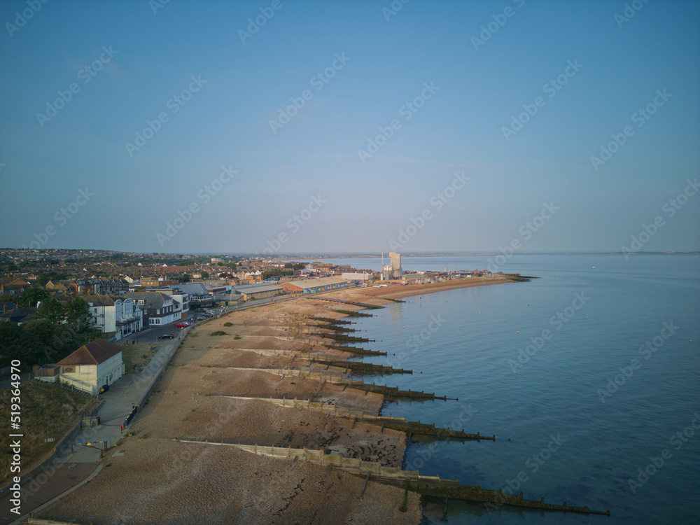Aerial drone view of whitstable beach groynes hotel harbour and open sea