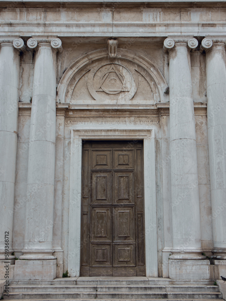 Venetian cathedral with columns and large wooden doors