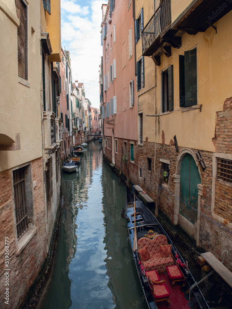 Canal with boats and old houses in venice