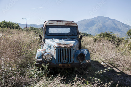 Old rusty blue truck for transporting food or animals in the Greek mountains