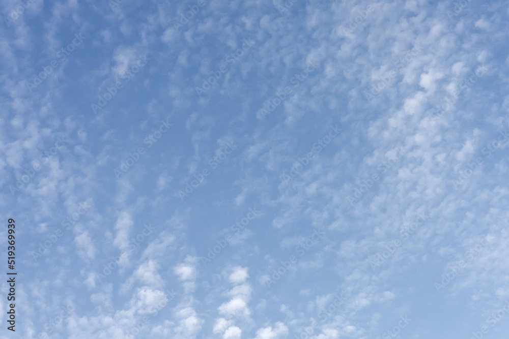 Blue sky background with small clouds.