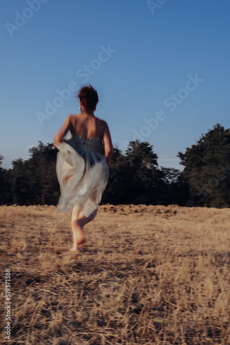 Blurred girl running in the countryside