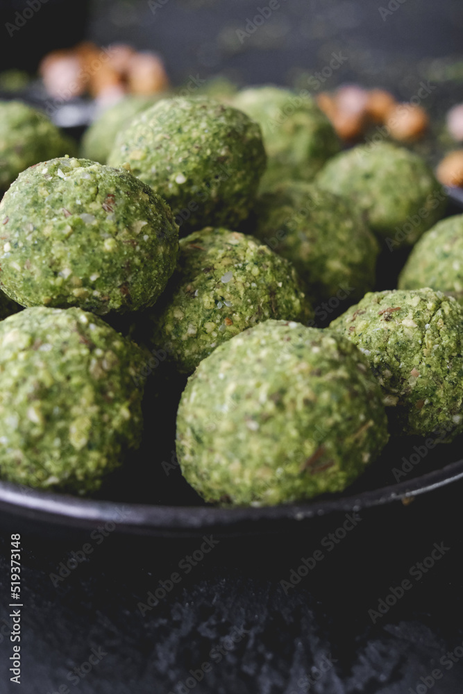 Fototapeta premium Ingredients to make falafel. Grounded chick peas. Green healthy food. Vegan delicious dish. Vegetarian meal. Food preparation. Arabic dish.