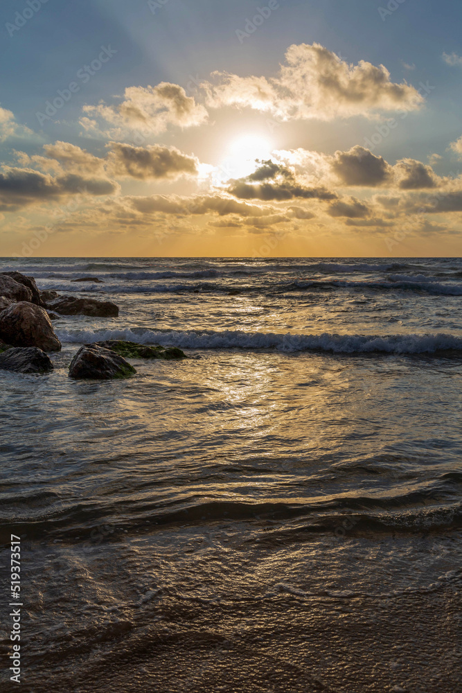 Beautiful summer sunset at the breakwater on the Mediterranean Sea. Israel.