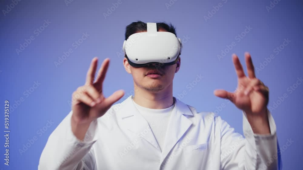 Korean man doctor using virtual reality glasses, playing video games, Asian guy nurse wearing new generation gaming headset for education, future technology concept. Korean man doctor using virtual reality glasses, playing video games, Asian guy nurse wearing new generation gaming headset for education, future technology concept.
