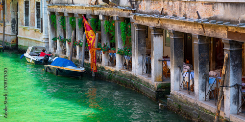 A beautiful Venetian restaurant situated on a turquoise canal photo