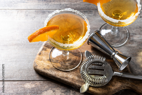 Sidecar cocktail with a sugar rim on wooden table