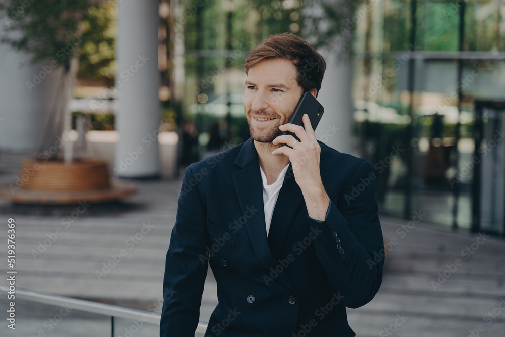 Confident man entrepreneur dressed in formal clothes makes phone call in roaming Confident man entrepreneur dressed in formal clothes makes phone call in roaming
