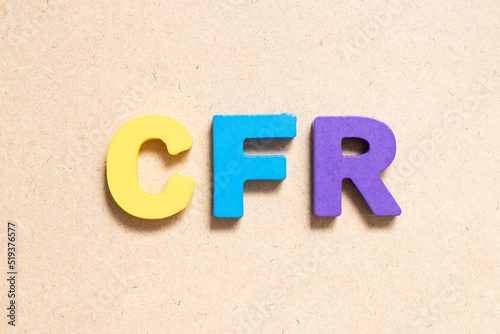 Color alphabet letter in word CFR (abbreviation of Cost and freight) on wood background