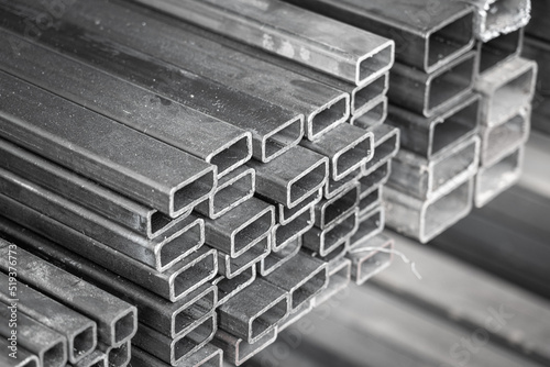 Metal or iron pipe in square box shape with cutting end. Construction building material and background textured, selective focus. Photo is grayscale. photo