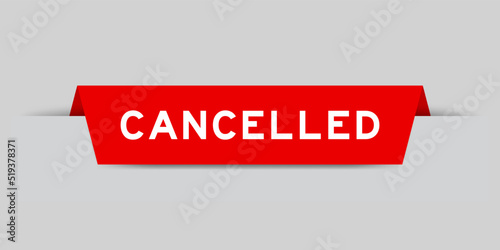 Red color inserted label with word cancelled on gray background