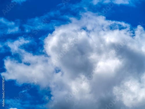 Dence cumulonimbus clouds over the blue sky.