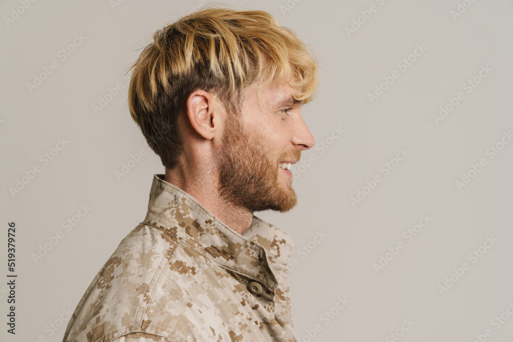 Fototapeta premium White military man wearing uniform smiling and looking aside