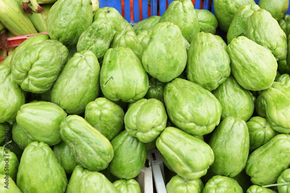 Healthy and fresh chayote neatly arranged in baskets for sale in traditional markets. fresh green vegetable background