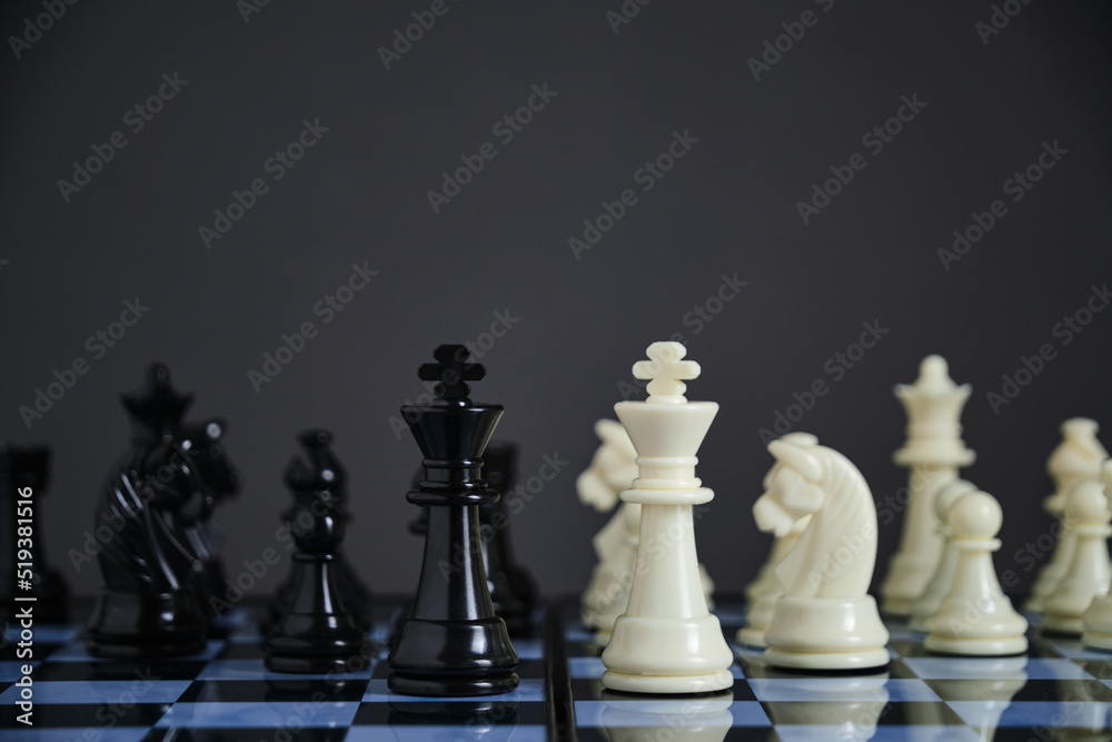 Black and white chess pieces on chessboard. Black and white chess pieces on chessboard.