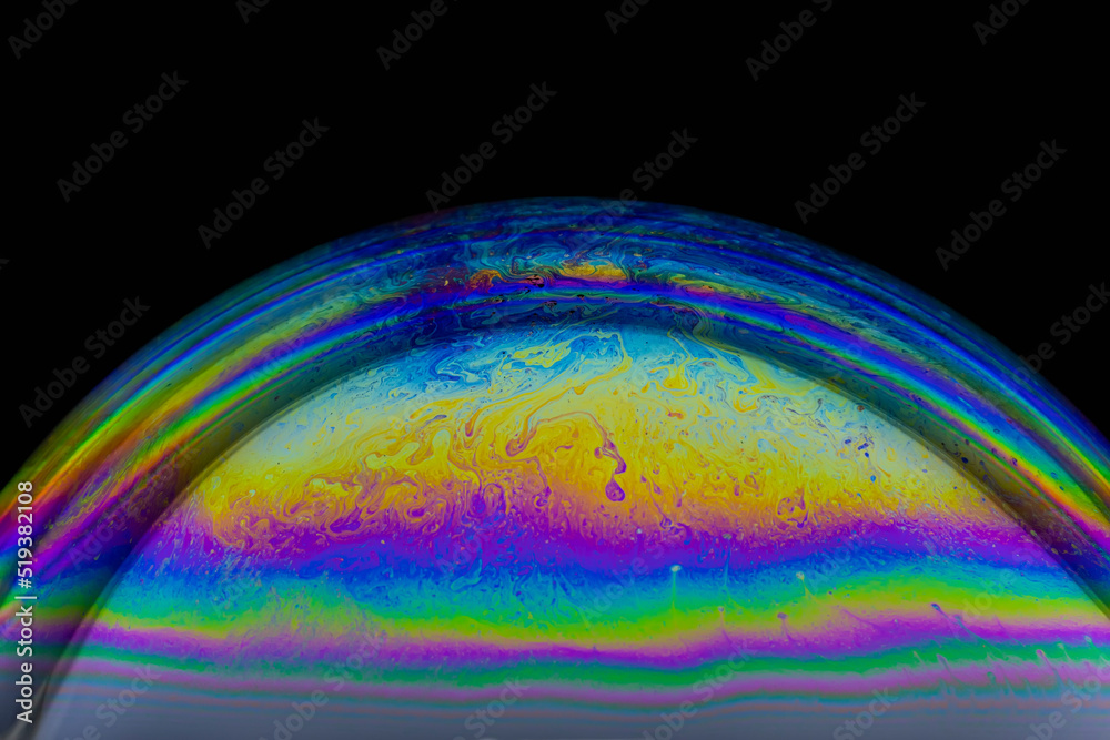 Closeup of colorful soap bubble on black background