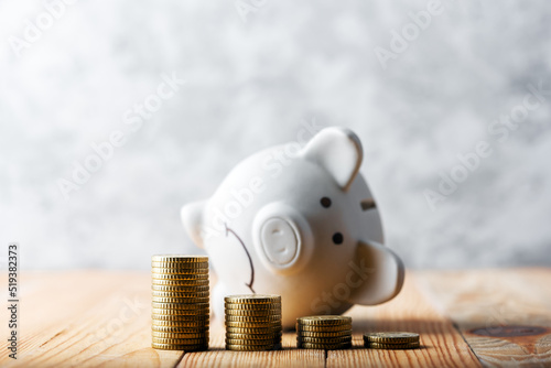 Obraz na plátně A sad piggy bank behind stacks of euro coins symbolizing the fall of monetary assets