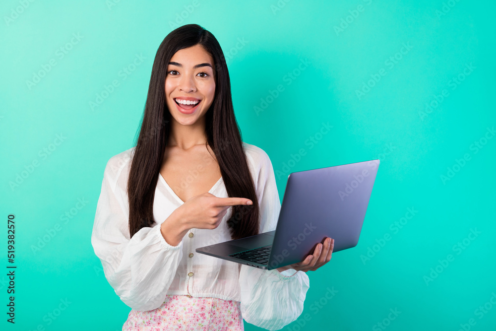 Photo of excited lady point netbook offer web discount wear white suit isolated cyan color background