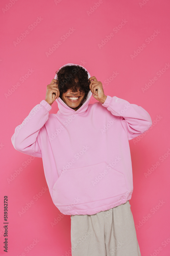 Young caribbean man with piercing smiling while posing on camera Young caribbean man with piercing smiling while posing on camera