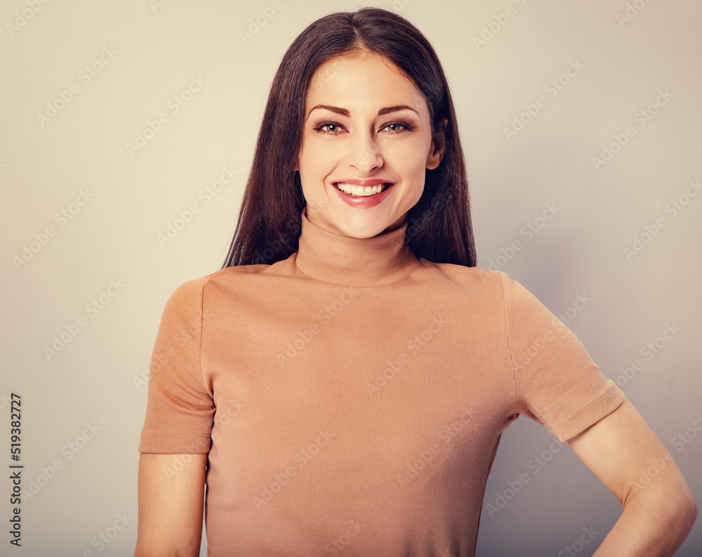 Beautiful young business woman in beige blouse thinking and looking front on toned background. Closeup vintage Beautiful young business woman in beige blouse thinking and looking front on toned background. Closeup vintage