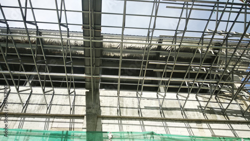 Wallpaper Mural SELANGOR, MALAYSIA -JUNE 16, 2021: Construction workers install trusses and roofing sheets at construction sites. Lightweight roof trusses used are more economical, sturdy and fast. Torontodigital.ca
