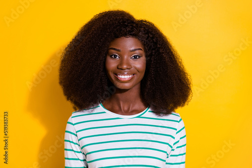 Photo of gorgeous positive lady curly hairstyle toothy beaming smile isolated on yellow color background © deagreez