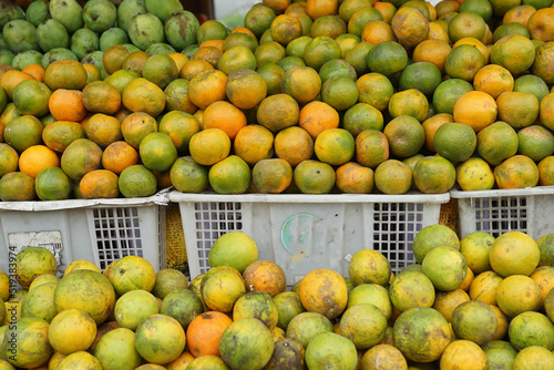 oranges and neat arrangement of fruit in baskets at the traditional market. healthy and fresh orange fruit background