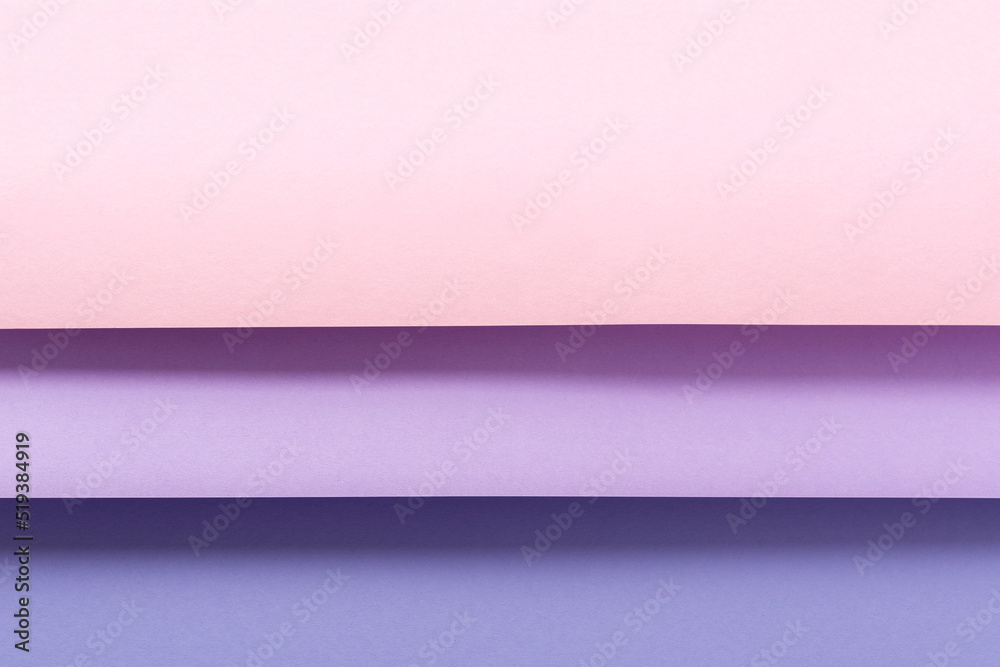 Design from folded paper pink lilac material backdrop. Top view, flat lay