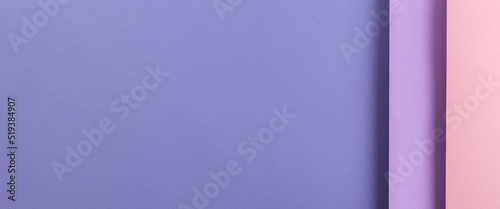Design from folded paper pink lilac material backdrop. Top view, flat lay. Banner