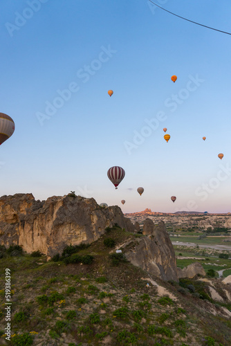 Landscape of Cappadocia, at sunrise with hot air balloons flying, view from a hot air balloon