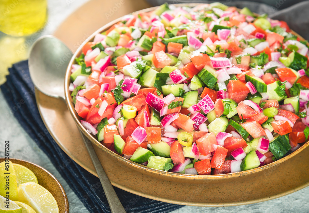 Arabic Cuisine; Traditional Egyptian salad (Salata Baladi). It consisting of fresh tomatoes, cucumbers, onions, chili, parsley, lemon and Middle Eastern spices.