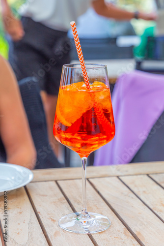 sommer aperitif drink with ice and straw on outdoor table
