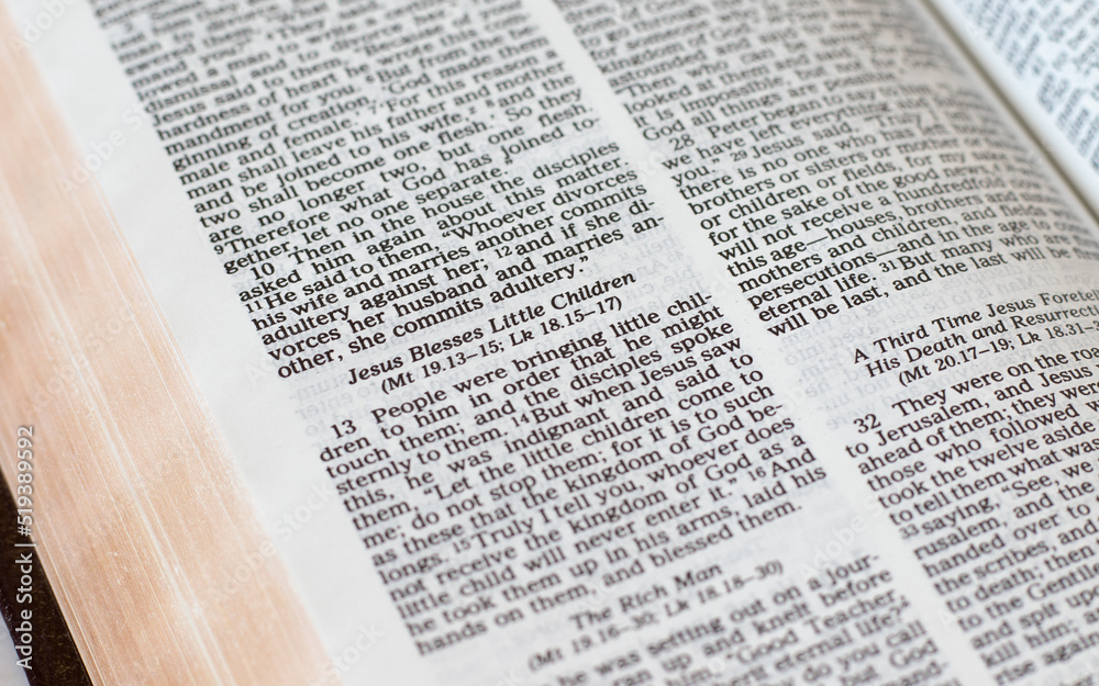 Jesus blesses little children, biblical verses in an open Holy Bible Book. Christian biblical concept of love, humility, the kingdom of God, blessing, trust, and faith in the LORD. A closeup. Jesus blesses little children, biblical verses in an open Holy Bible Book. Christian biblical concept of love, humility, the kingdom of God, blessing, trust, and faith in the LORD. A closeup.
