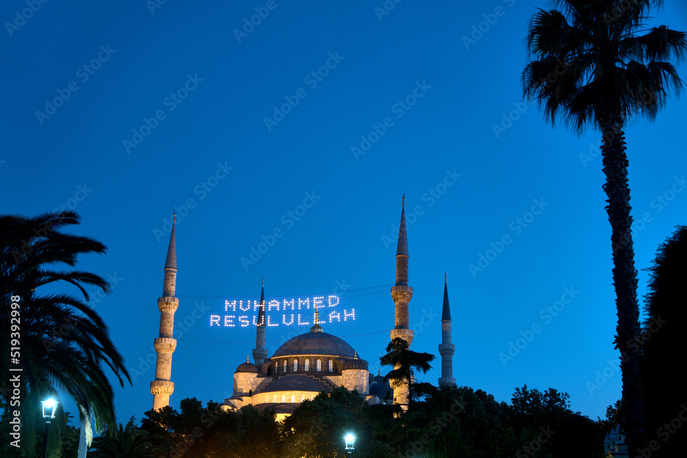 Istanbul, Turkey: Blue Mosque in the evening light. The illuminated inscription means: Muhammad is the messenger of Allah.