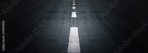 Asphalt road texture background, black tarmac surface with white marking stripes, Transport urban background, and Dark street texture detail.