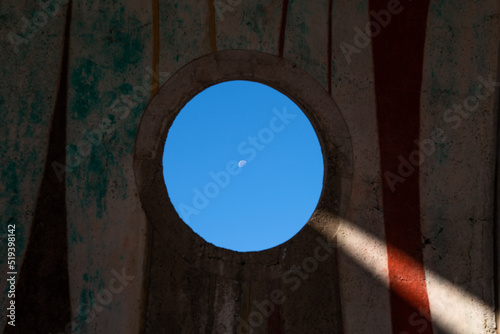 Circular Window in Arcosanti with Tiny Moon Arizona Desert photo