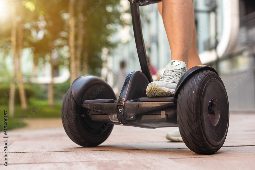 Beautiful woman stand near segway or hoverboard. self balancing electrical  scooter. foto de Stock | Adobe Stock