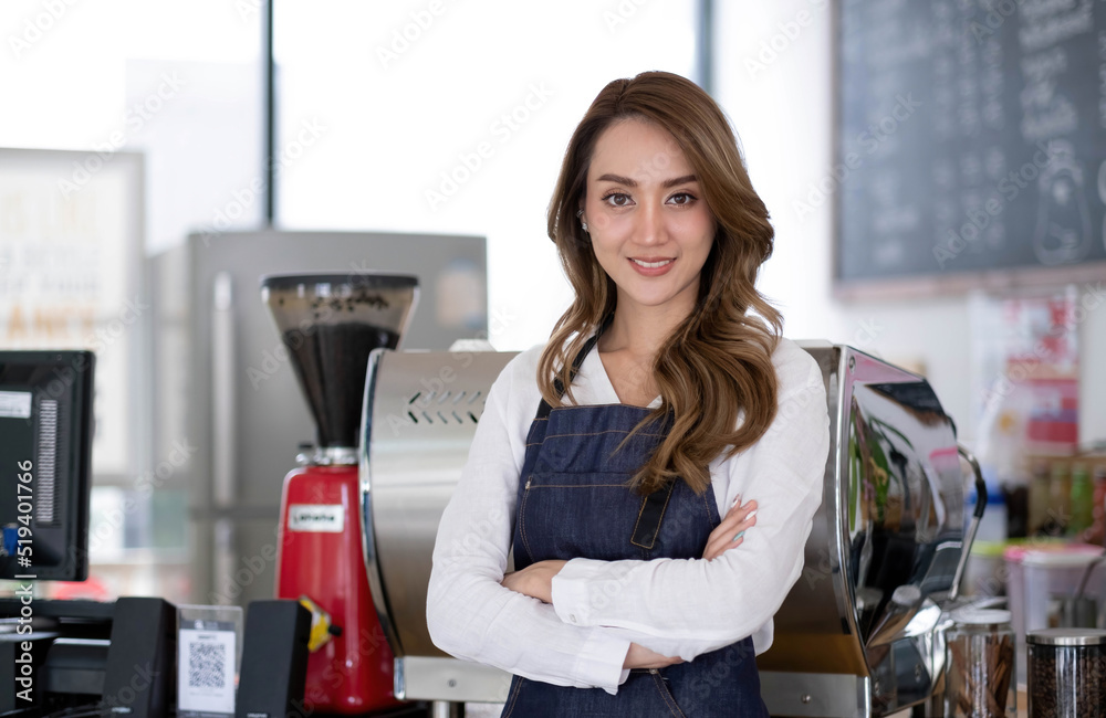 Startup successful small business owner sme beauty girl stand with tablet smartphone in coffee shop restaurant. Portrait of asian tan woman barista cafe owner. SME entrepreneur seller business concept