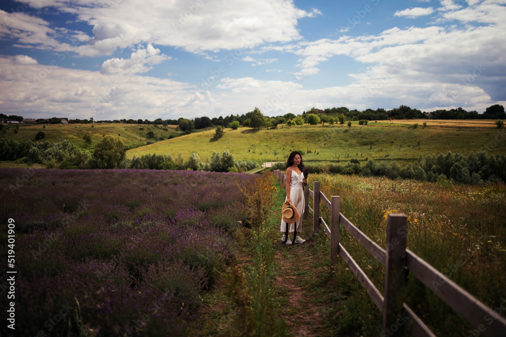 young beautiful elegant asian woman in white dress holding bouquet of lavender flower walking in bloom field outdoors leisure lifestyle