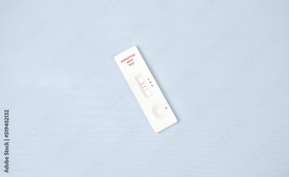 Monkeypox virus (MPXV) positive test result with medical cassette on white wooden background Monkeypox virus (MPXV) positive test result with medical cassette on white wooden background