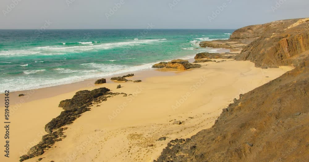 Empty sand Cofete beach with endless horizon. Volcanic hills in the background and Atlantic Ocean. Fuerteventura, Canary Islands, Spain. Playa de Cofete. Empty sand Cofete beach with endless horizon. Volcanic hills in the background and Atlantic Ocean. Fuerteventura, Canary Islands, Spain. Playa de Cofete.