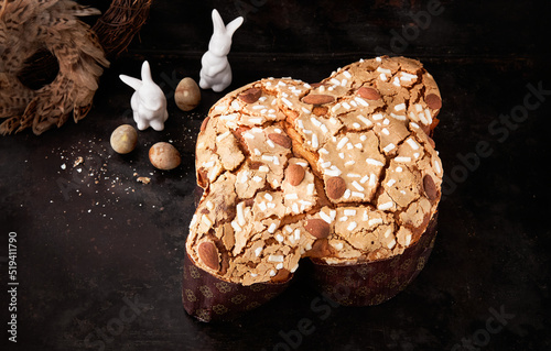 Colomba Pasquale, Italian Easter Dove Sweet Bread Colomba di Pasqua on dark surface. Selective focus, space for text. Traditional dessert in Italy.