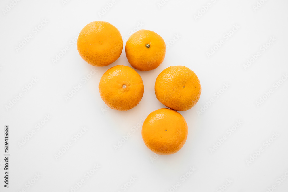 Tangerines with leaves and slices on white background