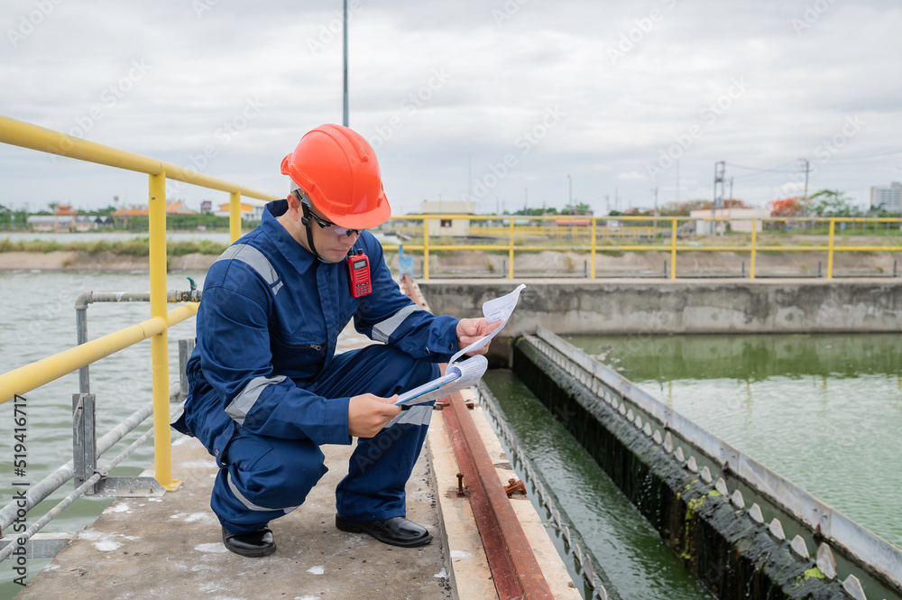 Water plant maintenance technicians, mechanical engineers check the control system at the water treatment plant. Water plant maintenance technicians, mechanical engineers check the control system at the water treatment plant.