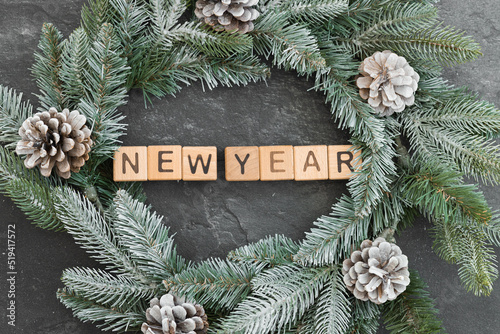 Fir branches with acorns on a white surface. New year 2023 photo