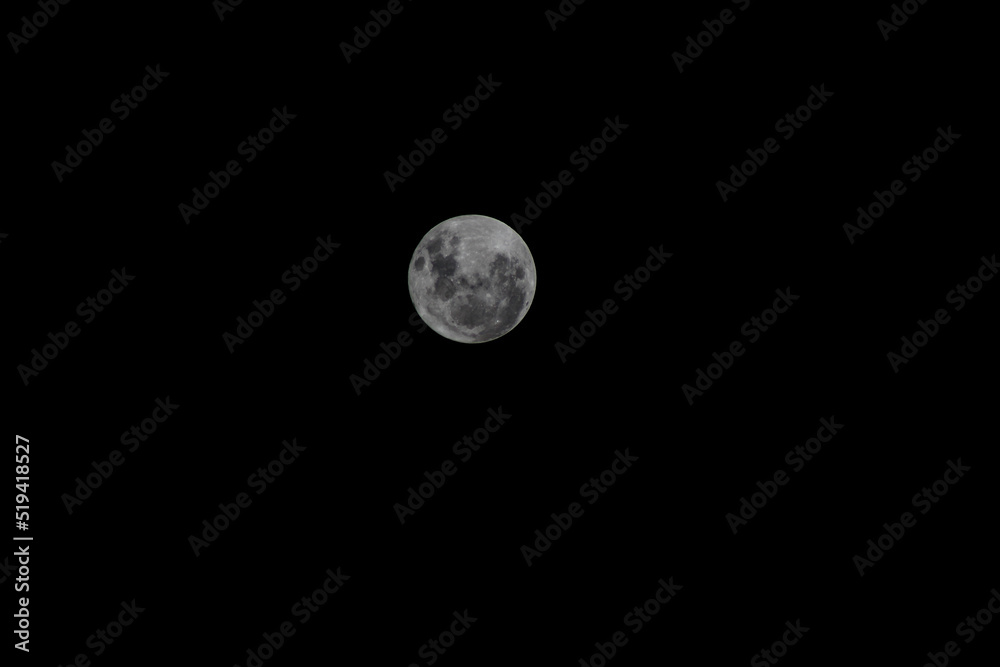 Full moon on the dark sky as a background. Jakarta, Indonesia. Full moon on the dark sky as a background. Jakarta, Indonesia.